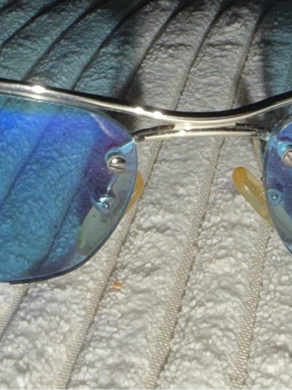 Dior Silver Logo Detail on Light Teal Surface - Picture 2 of 6